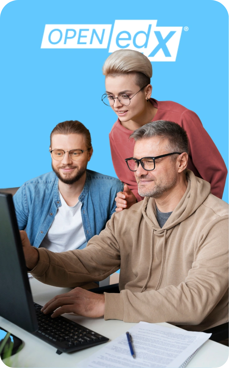 Team collaborating at a computer while working with the Open edX platform.