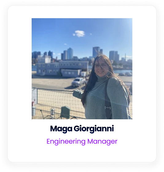 Maga Giorgianni, an Engineering Manager, standing outdoors with a city skyline in the background.