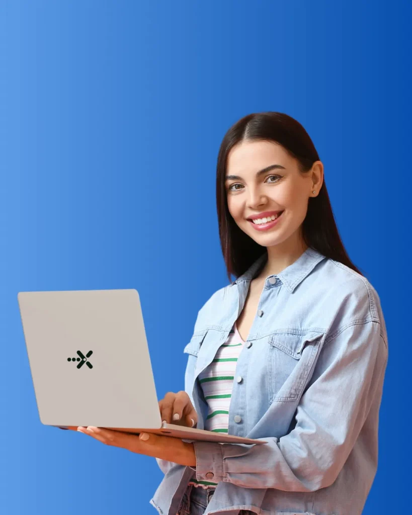 A smiling person holding a laptop with an edunext logo on the lid against a blue background.